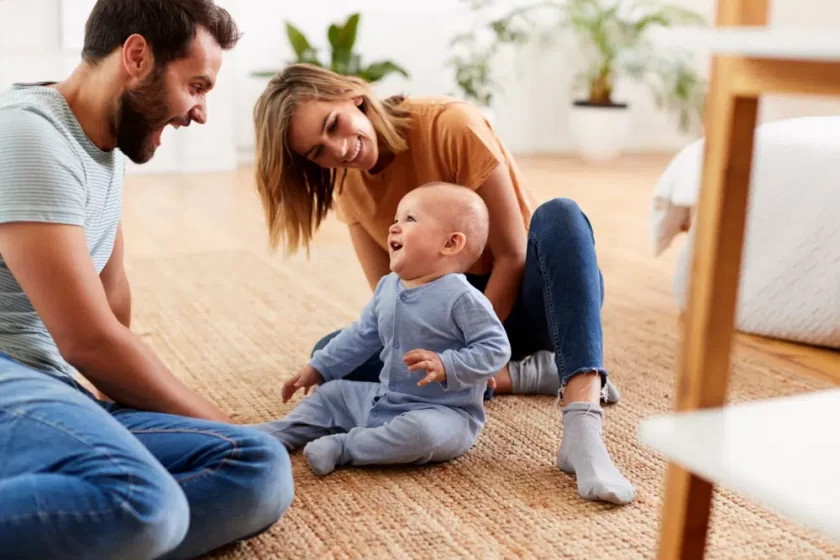 parents sitting on floor home playing