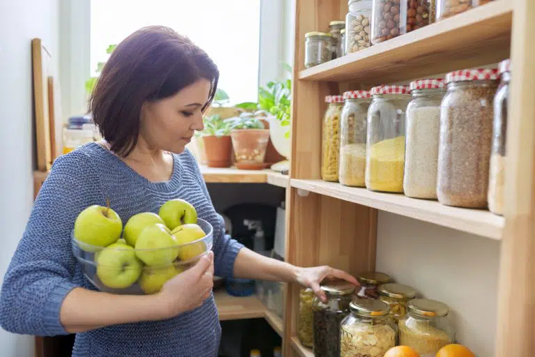 https://loftybuildinggroup.com.au/wp-content/uploads/2021/10/woman-bowl-green-apples-pantry-organizing.webp