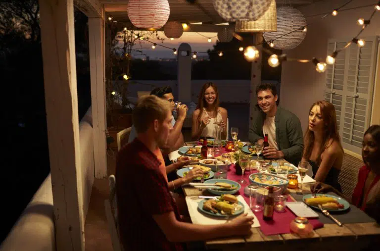 friends talking dinner party on patio